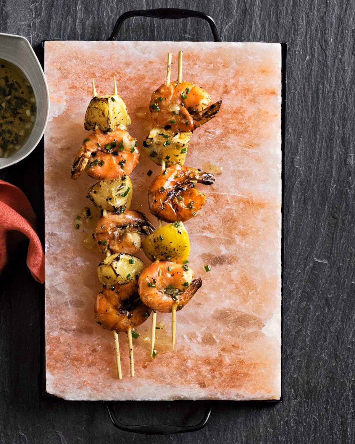 Scallops searing on a hot pink salt plate