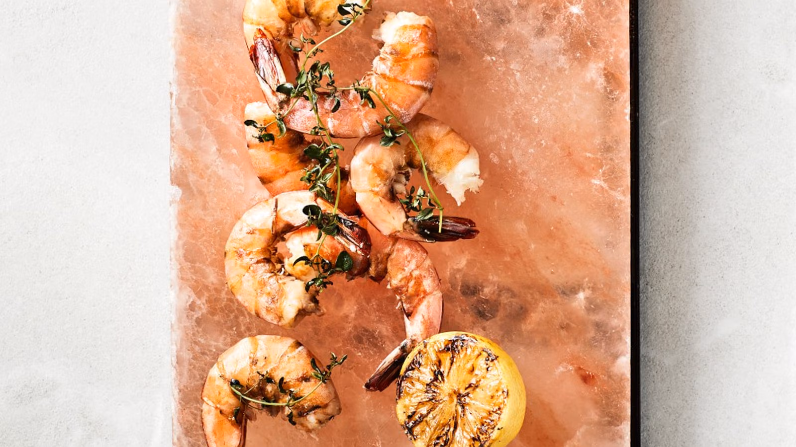 Salt plate positioned above an outdoor grill